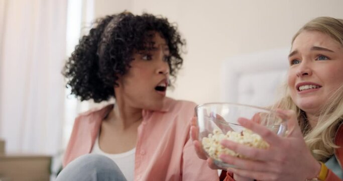 Jump, scare and women friends watching tv with popcorn on bed for horror, film or documentary at home. Television, terror and ladies in bedroom with fear for thriller, show or streaming scary movie