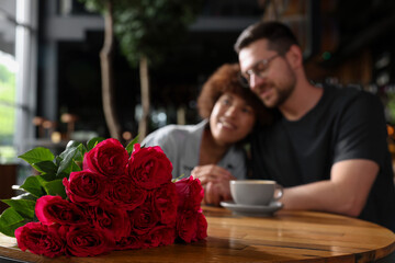 International dating. Happy couple spending time together in restaurant, selective focus