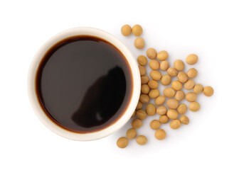 Obraz na płótnie Canvas Bowl of soy sauce and soybeans isolated on white, top view