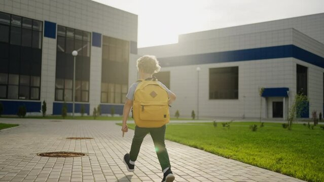 Cheerful Schoolboy Running To School In Sunny Morning, Back View, Slow Motion Shot, Happy Pupil