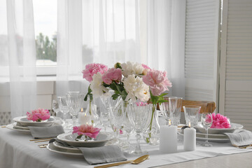 Stylish table setting with beautiful peonies in dining room