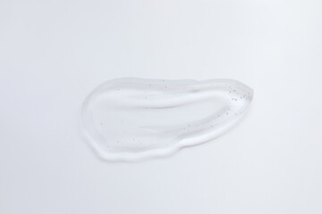 Smear of cosmetic oil on light surface