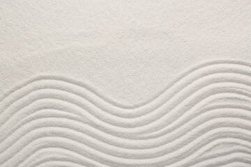 Fototapeta na wymiar White sand with pattern as background, top view. Zen concept