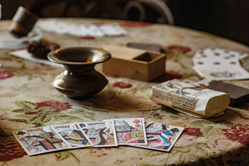 Antique card table with playing cards.