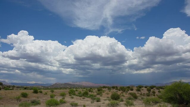 Churning Cumulus Clouds over Desert Landscape Timelapse