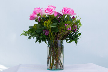 Many kinds of beautiful flowers put in vase on a white background