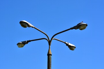 Strong with lots of power old quadruple lantern on a concrete pole top views of lamps against a...
