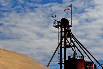 American Flag flys over Seed distribution manifold tower from bygone era 