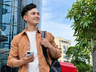 Portrait of young Asian man outside