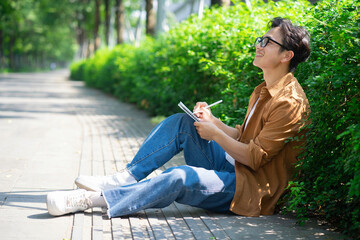 Portrait of young Asian man outside