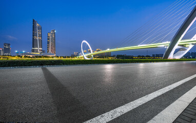 Asphalt road and bridge buildings with city skyline scenery in Nanjing, China.