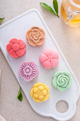 Traditional Chinese snow skin mooncakes for mid autumn festival with fruit, taro and matcha filling