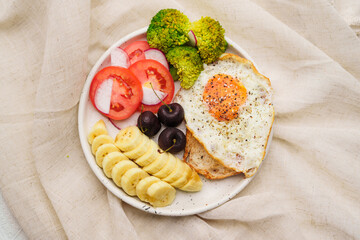 Breakfast, fried egg toast with vegetables and fruits.