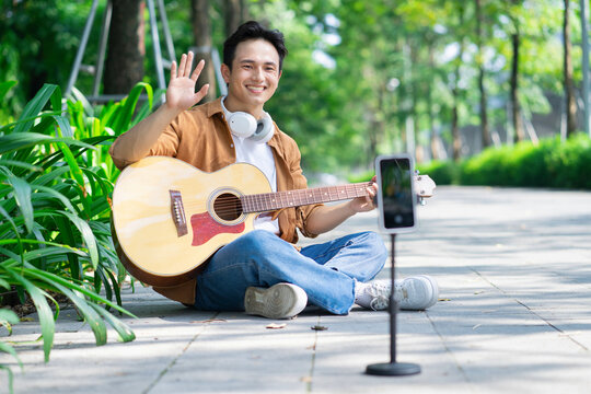 Portrait of young Asian man outside