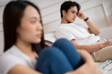 Photo of young Asian couple at home