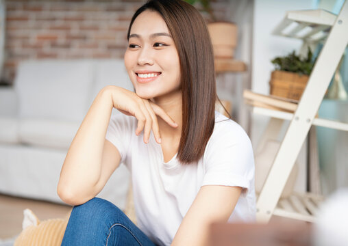 Photo of young Asian woman at home