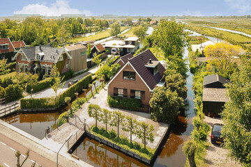 an aerial view of houses in the netherlands, taken from a drone's perspective on a clear blue sky