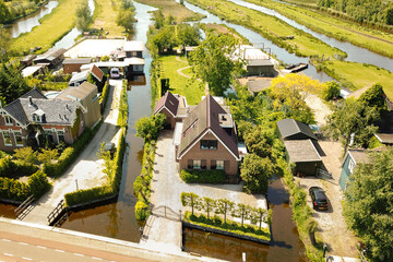 an aerial view of some houses in the middle of a river that has been flooded and is surrounded by...