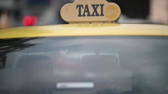 Taxi driving through the city.