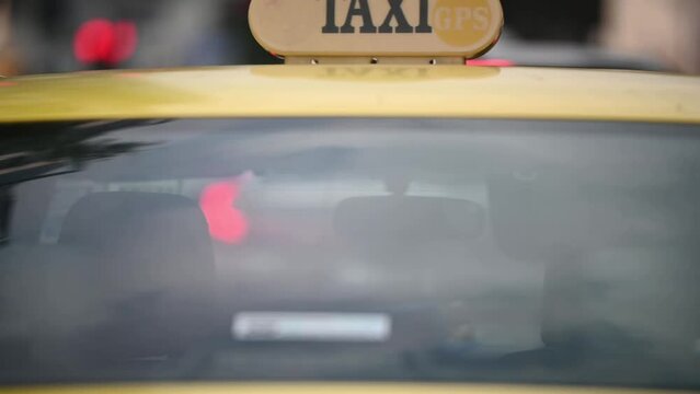 Taxi driving through the city.