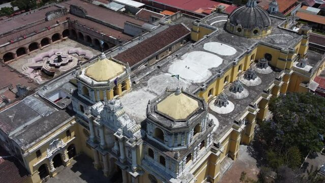 Aerial orbits sturdy Iglesia de La Merced church in Antigua Guatemala