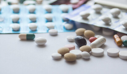 Several pills and capsules on the table.  medicine. drugs