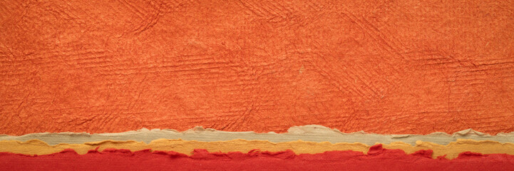 abstract landscape in orange and red tones - a collection of Huun papers handmade in Mexico, panorama web banner