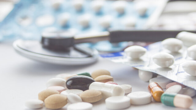 Several pills and capsules on the table.  medicine. drugs