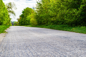 Beautiful empty asphalt road in countryside on colored background
