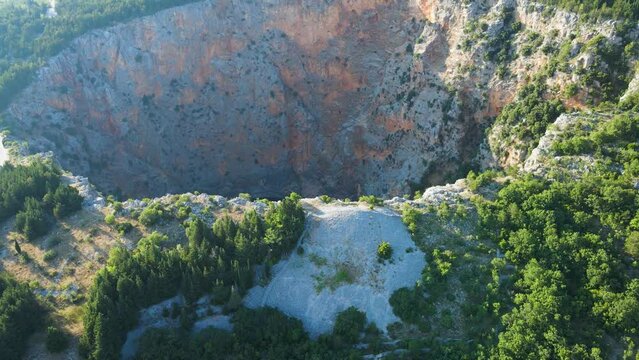 Revealing A Sinkhole Of Red Lake (Crveno jezero) Near The City of Imotski, Croatia. Aerial Drone Shot