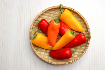 Vibrant chilli peppers. Assorted colorful varieties of hot and sweet peppers or chilies on a farm background. copy space. 