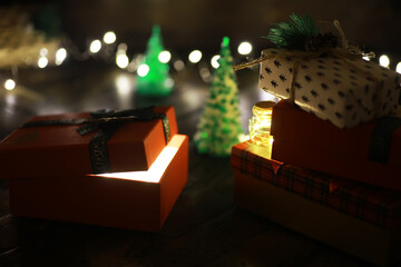 Gift boxes against a background bokeh of twinkling party lights. Luxury New Year gift. Christmas...