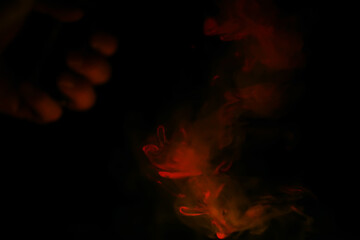 Red smoke over black studio background. Red steam on a black background. Copy space.