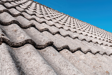Concrete roof tiles with blue sky in background