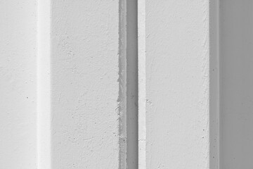 White concrete wall with reinforced post