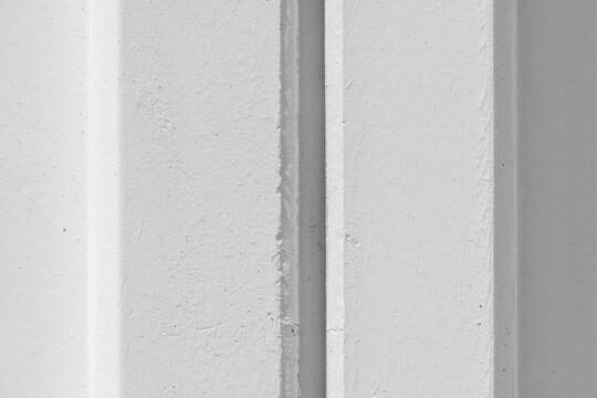 White concrete wall with reinforced post