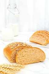 Whole wheat panini bread with almonds, nuts and walnuts, close-up shot indoors, photography light
