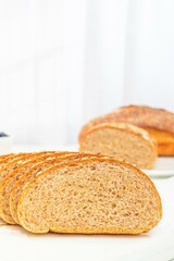 Whole wheat panini bread with almonds, nuts and walnuts, close-up shot indoors, photography light