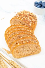 Whole wheat panini bread with almonds, nuts and walnuts, close-up shot indoors, photography light
