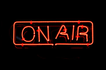 Red on air neon text on black background