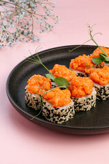 japanese sushi rolls with a shrimp cap on a plate