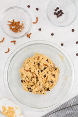 Chocolate Chip cookie dough in bowl with pretzels flyaway