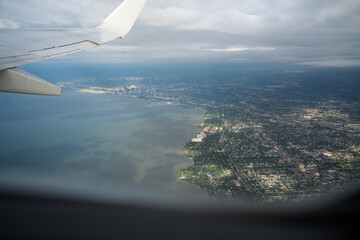 Naklejka na ściany i meble View from inside airplane flying over Cleveland