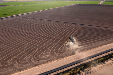 Aerial view of tractor making patterns in dry dirt and dust