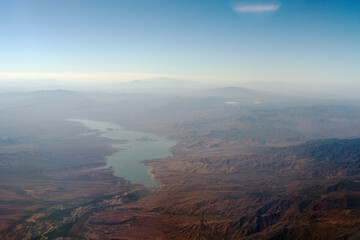 Large body of water in a rocky landscape viewed from high altitude