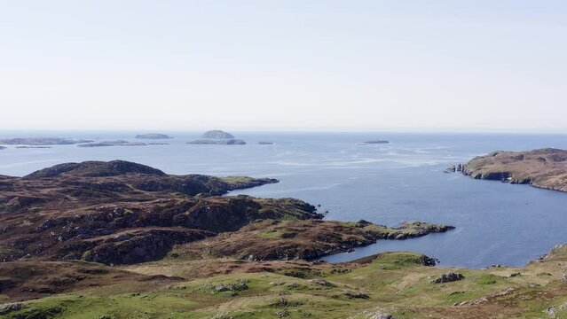 Ascending drone shot of the cliffs around the district of Carloway on the Isle of Lewis, part of the Outer Hebrides of Scotland. Filmed above the Dun Carloway Broch.