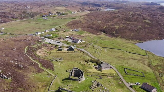 Descending drone shot of the 'Dun Carloway Broch' on the west coast of the Isle of Lewis, part of the Outer Hebrides of Scotland. The broch is a tourist attraction first built around 100AD.