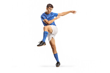 Young football player in a kicking pose