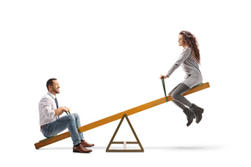 Young man and woman playing on a seesaw