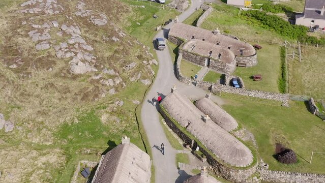 Descending drone shot of the Gearrannan Blackhouse Village on the Isle of Lewis, part of the Outer Hebrides of Scotland. A blackhouse is a traditional type of house which used to be common.